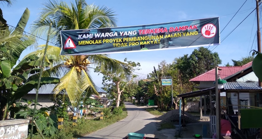 Spanduk penolakan proyek jalan yang ada Desa Tunggulo-Tunggulo Selatan Cs akses ke Kantor Kecamatan Tilongkabila, Kabupaten Bone Bolango. (Foto: Istimewa).