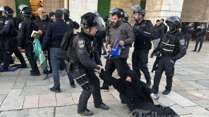 Pasukan keamanan Israel menindak jemaah Muslim Palestina yang duduk di halaman kompleks masjid Al-Aqsa di Yerusalem, pada 5 April 2023. Padahal para jemaah hendak beribadah Ramadhan. (AFP)