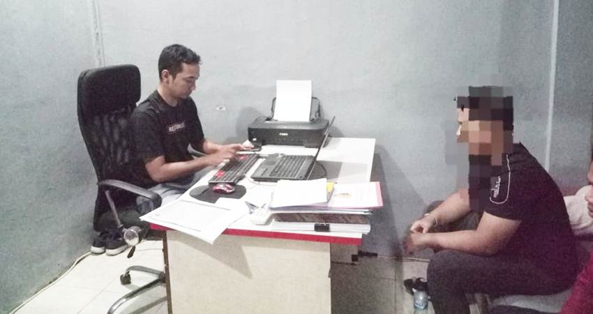 Tersangka dugaan tindak penganiayaan saat menjalani pemeriksaan penyidik Satreskrim Polres Bone Bolango.