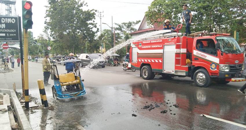 Kondisi bentor yang korsleting dan terbakar sementara dipadamkan oleh petugas damkar
