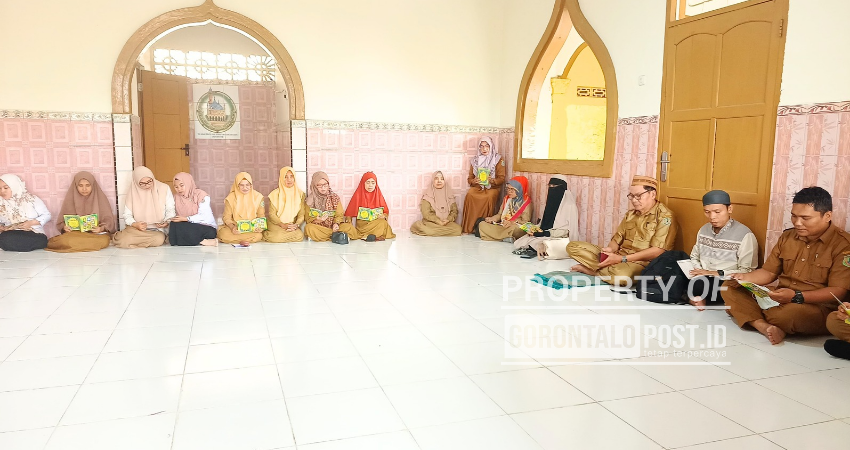 Kepala Sekolah SMP  8 Kota Gorontalo Drs. Abdul Hamid Taidi, M.Pd (kopiah keranji) didampingi Wakepsek Sofyan Nurdin M.Pd saat memantau aktivitas para guru yang sedang belajar mengaji menggunakan metode dirosa, Selasa (11/3/2025). Foto" Roy/Gorontalo Post)