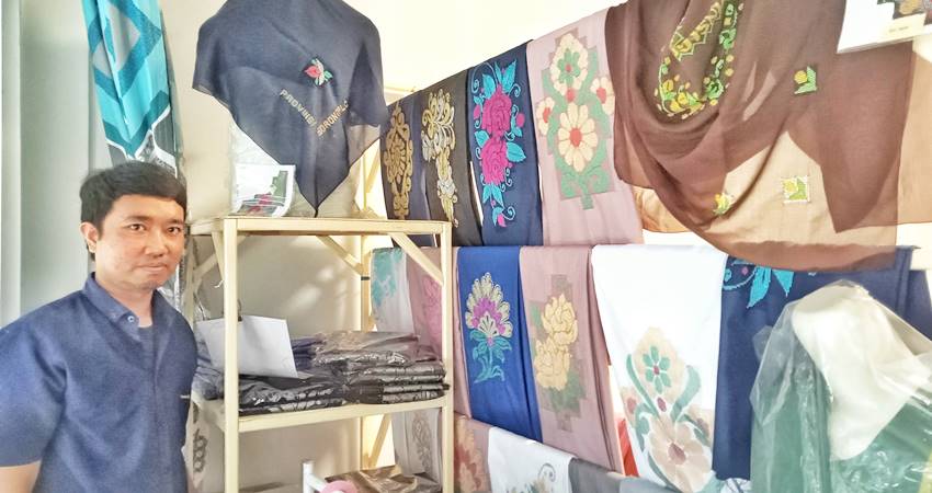 BANYAK DIMINATI - Mohamad Jafar Latif, pengusaha muda Gorontalo yang mengembangkan bisnisnya pada produksi karawo saat menunjukan sejumlah koleksinya, Sabtu (19/7). (foto : Sandyakala/mg/ Gorontalo Post)