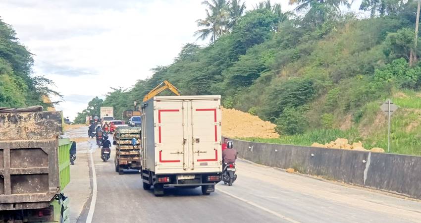 Suasana pembersihan jalan yang tertutup longsor di GORR, Desa Isimu Utara, Kecamatan Tibawa.