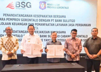 Gubernur Gorontalo, Gusnar Ismail dan Dirut BSG, Revino M. Pepah memperlihatkan dokumen kerjasama yang ditanda tangani.