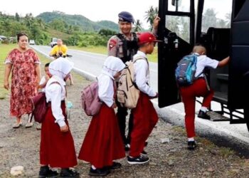 Personel Brimob Polda Gorontalo saat menjemput para siswa untuk pergi ke sekolah dengan menggunakan Bus Brimob Polda Gorontalo.