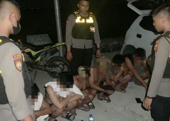 Aparat kepolisian Polda Gorontalo saat merazia sejumlah remaja yang berpesta miras di tempat umum.